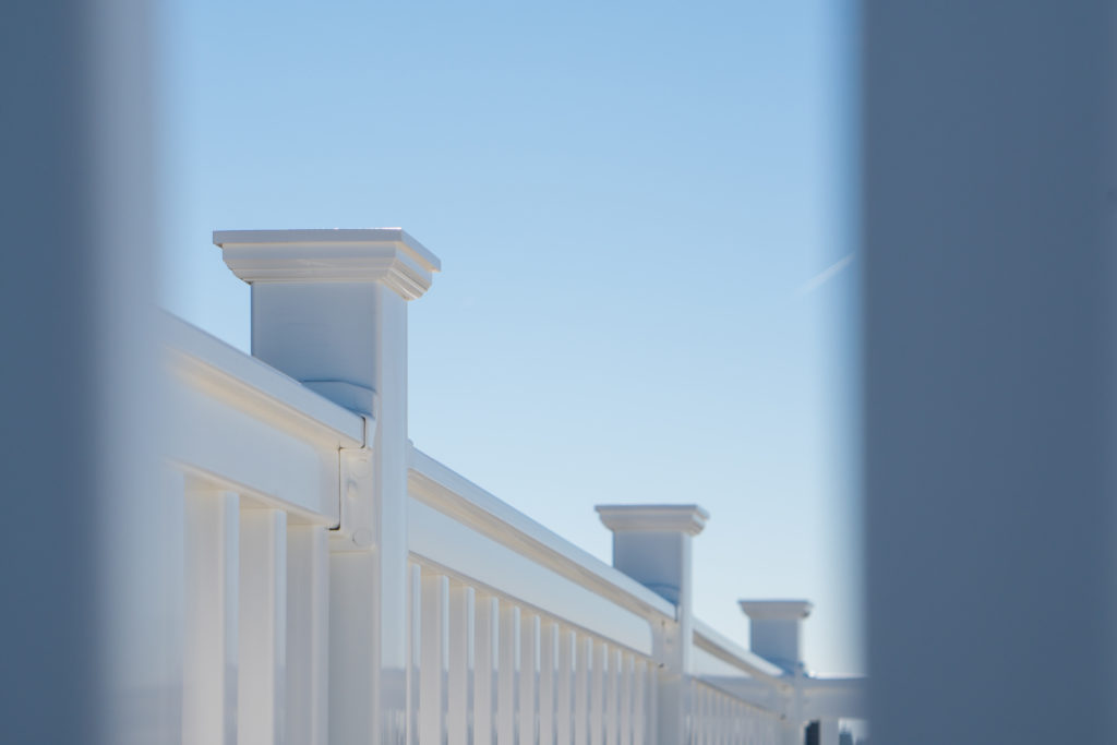 Close-up of vinyl railing against a blue sky